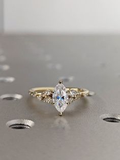 a close up of a diamond ring on a table