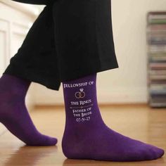 a person wearing purple socks with the words, fellowship of the rings on them