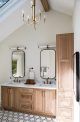 a large bathroom with two sinks and a skylight