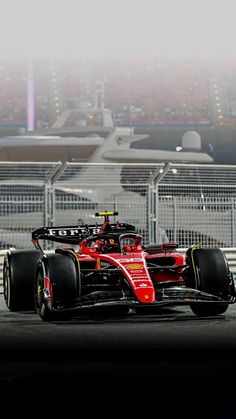 a red race car driving on a track