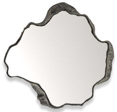 a mirror that is sitting on top of a white surface with black trimmings