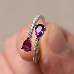 This is a gorgeous handmade creation. Its beauty is its simplicity & Elegance. The 4*6 mm pear shape faceted natural amethyst and lab ruby is crafted in solid sterling silver and with rhodium plated. CZs as accents. All item is sent in a beautiful gift box If you have any idea of design your ring,pls contact me directly. You can realize more lovely stuff clicking the link https://www.etsy.com/shop/knightjewelry?refshopsection_shophome_leftnav Please leave the correct address and you phone number Ruby And Amethyst Ring, Amethyst And Ruby Ring, Fine Jewelry Teardrop Crystal Ring For Anniversary, Teardrop Crystal Ring For Anniversary, Teardrop Amethyst Ring For Anniversary, Teardrop Ruby Ring For Anniversary, Teardrop Amethyst Ring For Gift, Pear-shaped Birthstone Ring For Gift, Teardrop Rings With Gemstone Accents For Anniversary