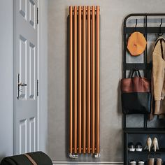 an orange radiator next to a coat rack