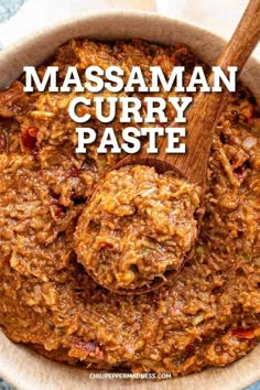 a close up of a bowl of food with a spoon in it and the words massaman curry paste on top