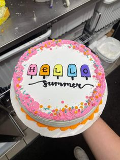 a birthday cake with the words hello summer written in colorful letters on it and sprinkles