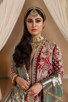 a woman in a red and gold outfit