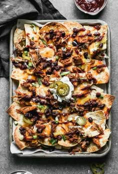 an overhead shot of nachos on a baking sheet