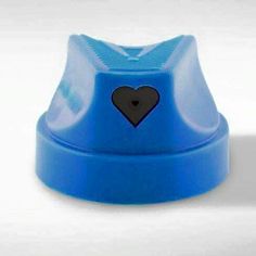 a blue cup with a black heart on the top is sitting in front of a white background