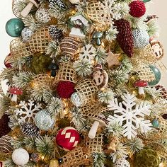 a christmas tree decorated with ornaments and burlucks in gold, green, red and white