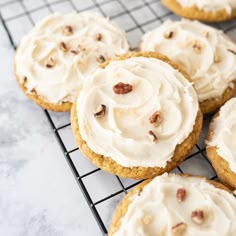 cookies with frosting and pecans on a cooling rack, ready to be eaten