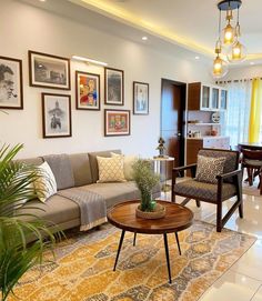 a living room filled with furniture and pictures on the wall