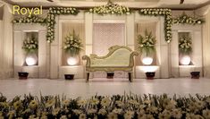 a room decorated with flowers and greenery