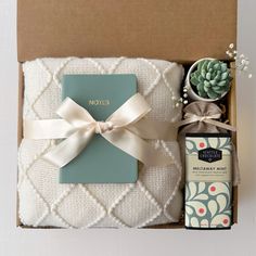 a gift box with a note book, soap and succulents