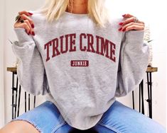 True Crime Junkie Sweatshirt,Crime Show Lover Crewneck,Serial Killers Shirt,Murder Shows And Comfy Clothes,True Crime Shows,True Crime Lover FREE SHIPPING All items are made to order and there are no returns on merchandise. Please be sure to double check your order before placement, and see sizing chart and size recommendations to find the best fit for you! Ideal for any situation, this UNISEX heavy blend crewneck sweatshirt is pure comfort. These garments are made from polyester and cotton. Thi Funny Graduation Shirts, Senior Sweatshirts, Homebody Shirt, City Sweatshirt, Team Edward, Forks Washington, Retro Sweatshirts, Graduation Shirts, Up Book