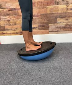 a person standing on top of a blue object