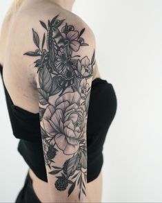 a woman with black and white flowers on her arm