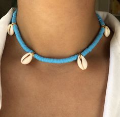 DEEP DIVE (Blue) * Ultimate Modern Boho Summer Necklace * Blue Enamel Coin Beads (6mm) * Natural cowrie shells * Stainless steel chain and carabiner in gold (no fading) * Full chain length: 45cm * Adjustable: yes * Beachworthy * Good vibes only! ➪  𝐴𝑙𝑙 𝑃𝑟𝑜𝑑𝑢𝑐𝑡𝑠 𝑎𝑟𝑒 𝑐𝑎𝑟𝑒𝑓𝑢𝑙𝑙𝑦 𝑝𝑎𝑐𝑘𝑎𝑔𝑒𝑑 𝑤𝑖𝑡ℎ 𝑙𝑜𝑣𝑒.  ➪  𝑃𝑎𝑐𝑘𝑎𝑔𝑒 𝑖𝑛𝑐𝑙𝑢𝑑𝑒𝑠: 𝐼𝑡𝑒𝑚 (𝑜𝑓 𝑐𝑜𝑢𝑟𝑠𝑒), 𝑎 𝑙𝑜𝑣𝑒𝑙𝑦 𝑉𝑒𝑙𝑣𝑒𝑡 𝐺𝑖𝑓𝑡 𝑏𝑎𝑔. ✲ 𝑇ℎ𝑒 𝑟𝑒𝑐𝑜𝑚𝑚𝑒𝑛𝑑𝑒𝑑 𝑐ℎ𝑎𝑖𝑛 𝑠𝑖𝑧𝑒 𝑓? Blue Beaded Beachy Jewelry, Beachy Blue Jewelry With Colorful Beads, Adjustable Blue Beachy Necklace, Blue Beachy Necklace, Blue Strand Beaded Necklaces For Vacation, Blue Beaded Strand Necklaces For The Beach, Blue Strand Beaded Necklaces For Beach, Handmade Blue Necklaces For The Beach, Light Blue Beaded Necklaces For The Beach