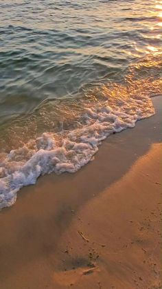 the waves are coming in from the ocean on the beach at sunset or sunrise time