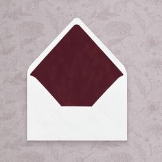 an envelope with a maroon paper on it