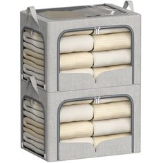 two storage bins filled with folded towels on top of each other, one in grey and the other in white