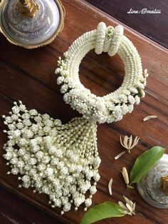 some white flowers are on a wooden table