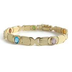 Vintage 1960's Italian Multicolored Gemstone Bracelet 14K Yellow Gold, 15.79 Gr This is a beautiful gemstone bracelet! Let us know if you have any questions. Circa: 1960's Gemstones: 5 oval gemstones 6 mm x 4.5 mm, 2.50 ctw (peridot, garnet, London blue topaz, amethyst, citrine) Metal: 14K yellow gold Weight: 15.79 grams Stamped: 14K, ItalyLength: 7.25 inches Width: 8.4 mm Clasp: snap clasp with safety latch V0086 Fine Jewelry Bracelets, London Blue Topaz, London Blue, Bracelets And Charms, Architecture Model, Gemstone Bracelet, Chain Link Bracelet, Blue Topaz, Citrine