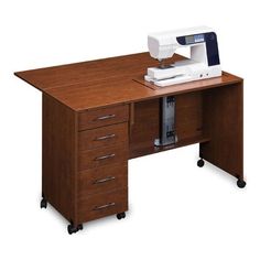 a sewing machine sitting on top of a wooden desk next to a drawer with drawers