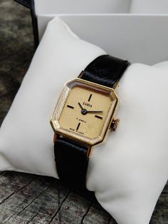 "Vintage women's gilded small watch . The watch looks very elegant on a woman's wrist and goes well with other accessories. This watch perfectly captures the vintage style! The watch will be a great gift for lovers of vintage accessories. The watch is delivered in a beautiful box, so it is perfect as a gift. Peculiarities Brand Name: Zaria Made in USSR. Movement - mechanical. Case size - 22 mm (0,8 inch) Strap:  eco-leather, length suitable for a wrist up to 17 cm  Year of issue - 1980s Case: gi Yellow Gold Watch Accessories With Rectangular Dial For Evening, Vintage Watch Accessories With Rectangular Dial For Evening, Antique Gold Watch Accessories With Diamond Hour Markers, Timeless Evening Watch With Gold Clasp, Antique Gold Watch With Diamond Hour Markers, Vintage Yellow Gold Watches For Evening, Classic Yellow Gold Watch For Gift, Timeless Rectangular Dial Jewelry For Evening, Vintage Yellow Gold Jewelry And Watches For Evening