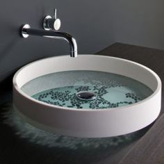 a white sink sitting on top of a wooden counter