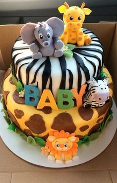 a baby shower cake decorated with animals and zebras