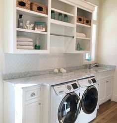 the laundry room is clean and ready to be used as a washer and dryer