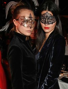 two women with masks on their faces are posing for a black and white photo together