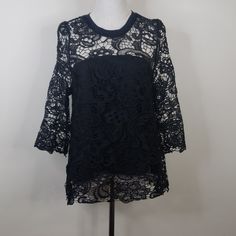 Open Back Lace Overlay Blouse. Nwot Arm To Arm 19" Length 27" Black Lace Top With Crew Neck, Black Lace Crew Neck Top, Party Blouse With Lace Top And Crew Neck, Spring Black Crochet Lace Top, Evening Tops With Black Lace Sleeves, Black Lace Top With Lace Work, Black Lace Sleeve Tops For Evening, Black Evening Tops With Lace Sleeves, Black Lace Blouse For Evening