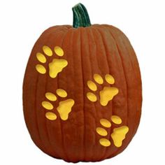 a carved pumpkin with paw prints on it