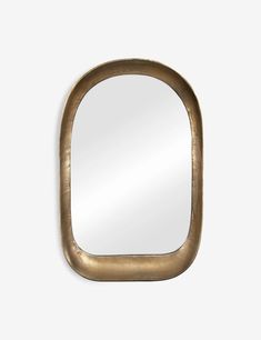 an oval mirror with a gold frame