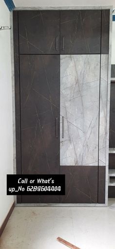 a cabinet with marbled doors and shelves in a room that is being remodeled to look like it has been painted black