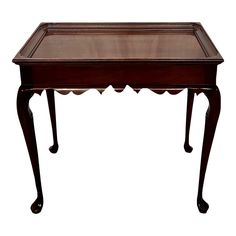 an antique wooden table with glass top and two drawers on the legs, isolated against a white background