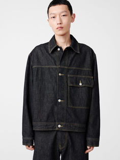 Diverting from the typically slim cut of a denim trucker jacket, Petar has a relaxed, boxy fit that feels distinctly modern. It has been constructed in a rigid Italian denim with a strong salt and pepper grain and tobacco thread at the seams.---- Large front patch pocket - Side pockets built into... Indigo Relaxed Fit Denim Jacket, Men's Luxury Utility Denim Jacket, Casual Rigid Denim Jacket, Relaxed Fit, Unstructured Denim Button-up Jacket, Luxury Garment Washed Men's Denim Jacket, Studio Nicholson, Denim Trucker Jacket, Knit Outerwear, Black Denim Jacket