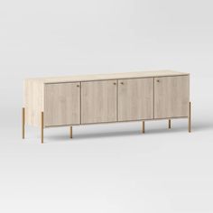 the sideboard is made from wood and has three drawers, one with two doors