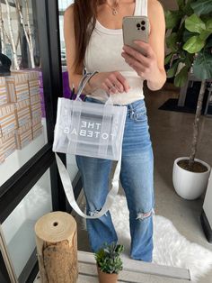 This inspired CLEAR tote bag will be the prefect accessory for all things concert, stadium events, and sporting events this summer (or any time of year). Adjustable strap Easy to clean 10.63" x 4" x 8.27" Preorder items will ship approx 14 business days from order. Trendy Rectangular Mesh Bags, Trendy Rectangular Mesh Bag, Summer White Shoulder Bag For On-the-go, Trendy Mesh Bag For Daily Use, Summer Mesh Shoulder Bag For Shopping, Summer Rectangular Mesh Shoulder Bag, Summer Mesh Rectangular Shoulder Bag, Large Capacity Mesh Bag For Summer, Casual Mesh Bag With Large Capacity