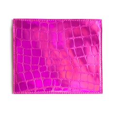 a pink alligator skin wallet on a white background with clippings to the side