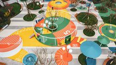 an aerial view of colorful playgrounds and trees