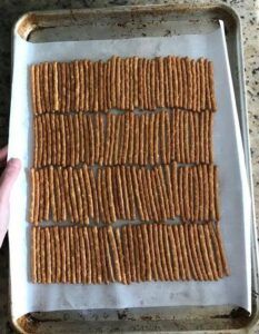 crackers are arranged on a baking sheet in the shape of rectangles to form squares