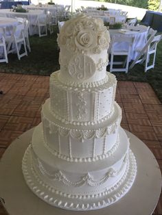 a large white wedding cake sitting on top of a table