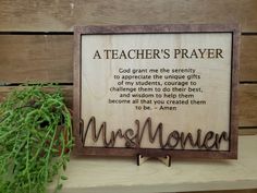 a teacher's prayer is displayed on a shelf next to a potted plant