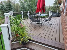 a deck with chairs and an umbrella on it