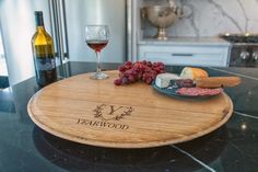 a wine glass and cheese board on a kitchen counter