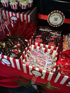 candy bar with red and white striped boxes filled with candies