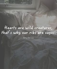 an instagram page on pinterest showing someone's bed with the caption hearts are wild creatures, that is why our ribs are cages?