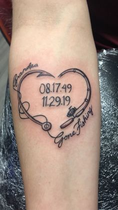 a heart shaped tattoo with the date and name on it